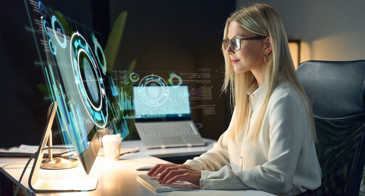 A content writer working with AI-assisted tools on a large screen A content writer working with AI-assisted tools on a large screen